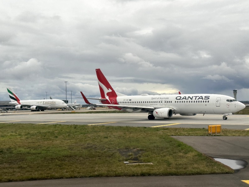 A Qantas 737-800 and Emirates A380 at Melbourne Airport