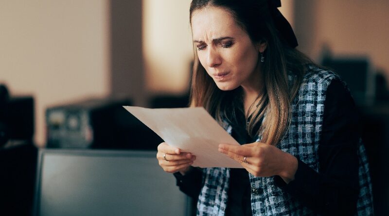woman squinting to read fine print