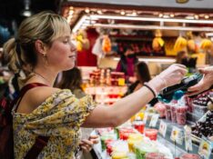 Woman paying at a bazaar with credit card