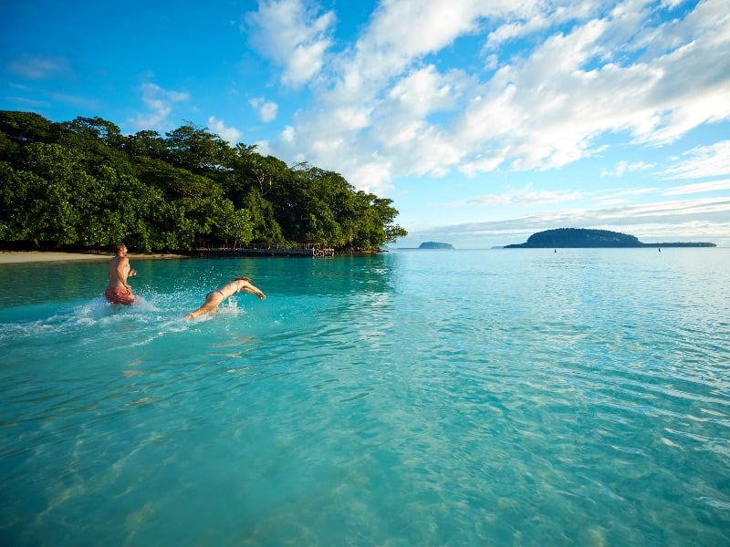 Visitors swim at Champagne Beach, Espiritu Santo Island, Vanuatu.