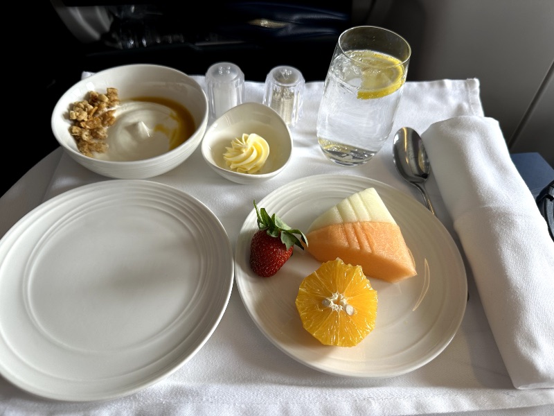 Seasonal fresh fruits and Greek yoghurt with mango coulis