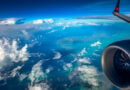 View of the wing flying over Caribbean islands on an Air Canada Boeing 737-8