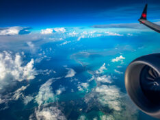 View of the wing flying over Caribbean islands on an Air Canada Boeing 737-8