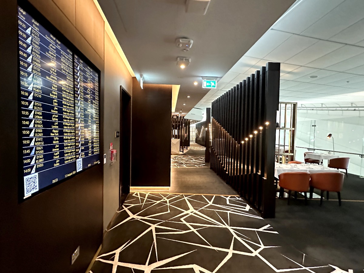 Flight departure information board in the Etihad First Class Lounge in Abu Dhabi