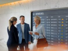 Qantas First Lounge host with boarding pass