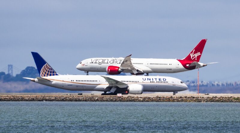 San Francisco / CA / USA - Virgin Atlantic aircraft landing at San Francisco Airport while an United Airlines aircraft is waiting to take off