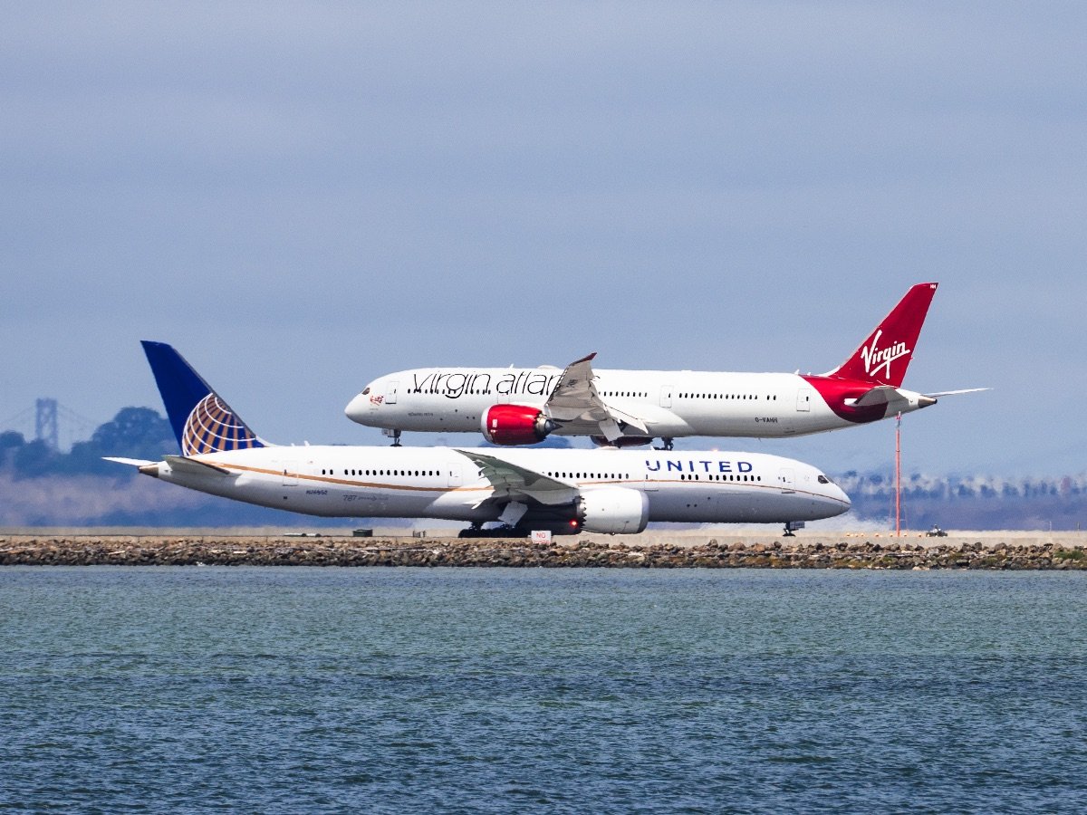 San Francisco / CA / USA - Virgin Atlantic aircraft landing at San Francisco Airport while an United Airlines aircraft is waiting to take off