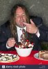 long-haired-fat-man-eating-stuffing-himself-with-cake-and-ice-cream-ADYP8A.jpg